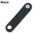 Black PU leather cable organizer strap detail view, metal snap button close-up shot. - Black