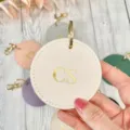 Personalized round PU leather keychain with custom gold foil initials, elegant bag charm. - White