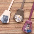Hand-painted leather key bell bag charm detail, showing exquisite animal portraits. - Apricot