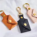 Detailed closeup of PU leather folding photo keychain pouch in multiple attractive colors. - Apricot
