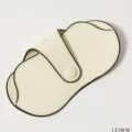 Detail view of portable PU leather glasses case with snap button and contrast black piping. - White