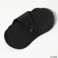 Detailed view of the black PU leather glasses case with secure snap button closure design. - Black