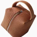 Brown PU leather square cosmetic bag detailed view showing fine texture and smooth zipper. - Brown