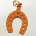 Orange leather horseshoe bag charm, stylish PU leather U-shaped pendant for handbags and purses. - Orange