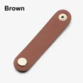 Close-up detail of the brown PU leather cord organizer strap with metal snap buttons. - Brown