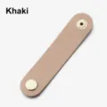 Detailed shot of PU leather earphone cable organizer strap, mini portable cord keeper. - Khaki