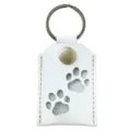 Detailed view of white PU leather pet memorial hair storage keychain with paw prints. - White