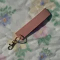 Pink PU leather wristlet keychain with gold metal hardware, stylish and practical accessory. - Pink