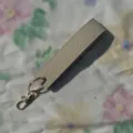Beige PU leather wristlet keychain with gold metal hardware, stylish strap key holder. - Apricot