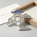 Close-up detail of a Chinese style pavilion brooch featuring pearls and sparkling rhinestones. - Pine Pavilion Scenery