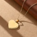 Close-up detail of a minimalist double heart gold pendant necklace, stainless steel jewelry. - Gold Heart