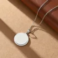 Stainless steel blank round pendant necklace with fine chain, minimalist jewelry detail shot. - Steel Color Round
