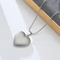 Close-up detail of stainless steel heart locket pendant necklace on elegant silver snake chain. - Heart Engraved (Style 2)