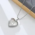Close-up of vintage stainless steel heart locket pendant necklace with delicate chain details. - Double Heart Vine (Style 7)