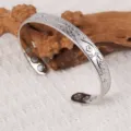 Vintage metal cuff bracelet featuring engraved plum blossoms and inner magnetic stones. - Bracelet (ZK058) / Silver
