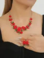 Detailed shot of red camellia flower pearl necklace and earrings set, elegant floral jewelry design. - Red Set