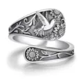 Detailed close-up of vintage silver adjustable ring featuring hummingbird and sunflower relief design. - Open Adjustable / Antique Silver