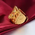 Close-up detail of the golden dragon ring featuring intricate relief texture on red satin. - Style 1 (KY1303) / Adjustable Open Design
