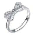 Close-up detail of silver bow ring shank, featuring shimmering cubic zirconia stones and S925. - Size 5 / Platinum