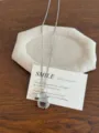 Silver-colored necklace with faceted crystal pendant on display card for women daily wear. - White Crystal Bottle Style (XL5016)