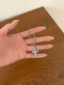 Detailed view of silver clavicle chain with light blue crystal cross pendant, sparkling fashion. - Blue Cross Style (XL5250A)