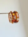 Detail shot of multi-layer stacked resin tortoise shell and bead bangles bracelet set. - Amber Pattern Beaded Bracelet Set (SL0414)