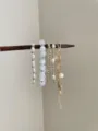 Detail shot of multi-layer stackable beaded bracelets featuring pearls and starfish pendant. - Starfish Artificial Pearl Style