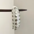 Detailed view of white resin studded bangle bracelet, silver metal dots accessory close up. - Punk Studded Bangle (SL0552B)