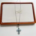 Detailed view of a vintage light blue glass cross pendant long sweater chain with silver chain. - Blue Cross Necklace (XL4900D)