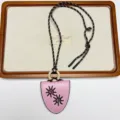 Detail view of the retro leather glasses holder necklace pendant with sun motif and wooden ring. - Sunflower Glasses Clip Necklace (XL3830B) / Pink