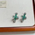 Detailed view of emerald cubic zirconia cross earrings, delicate baguette green stones. - Cross Earrings (EH2816)