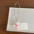 Close-up detail of beaded pearl bear pendant necklace with sweet bow and heart chain. - Pink Bear Style (XL4960D)