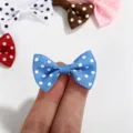 Macro detail of a mini blue polka dot ribbon bow being held for DIY accessory sizing. - Polka Dot Bow / Sapphire Blue