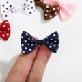 Close-up of mini polka dot ribbon bow being held to show small scale for DIY crafts - Polka Dot Bow / Black