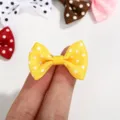 Macro detail view of a tiny yellow polka dot ribbon bow for DIY crafts and hair accessories - Polka Dot Bow / Yellow
