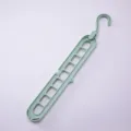 Space-saving 9-hole magic hanger in light green plastic for closet organization - 400 Pieces/Pack / Green
