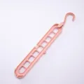 Space-saving pink 9-hole magic hanger with rotating hook for closet organization. - 400 Pieces/Pack / Pink