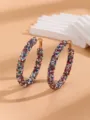Detailed view of large colorful rhinestone hoop earrings, shining crystal fashion jewelry for women. - Colorful