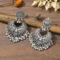 Bohemian silver tone hollow metal dangle earrings with intricate filigree and small bell charms. - Antique Silver