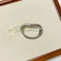 Detailed view of the vintage irregular metallic brooch, showcasing smooth curved design and polish. - Silver Oval Brooch (XZ0161)