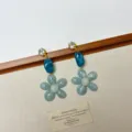 Detail shot of vintage style resin flower earrings with crystal studs and blue geometric drop. - Blue Flower Style (EH2584)
