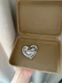 Close-up view of a chic liquid metal heart brooch showcasing its unique shiny texture and style. - Heart (XZ0166) / Silver