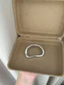 Close-up view of the minimalist irregular metal brooch displayed inside a natural box. - Oval (XZ0161) / Silver