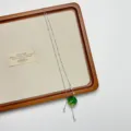 Close-up detail of the niche green apple pendant necklace, featuring delicate silver chains. - Apple Tassel Pendant Necklace Style (XL3983)