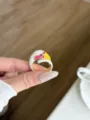 Close-up of enamel bird ring detail showing metal craftsmanship and colorful oil dripping. - White Parrot Style (JZ0875D)