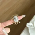 Close-up of the creative ocean style crab ring detail, featuring a metallic finish and unique shell design. - White Crab Rhinestone Style (JZ0917) / White