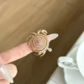 Close-up detail of a stylish metal open ring featuring an ocean crab and shell design. - Crab Sea Snail Texture Style (JZ0919) / Brown