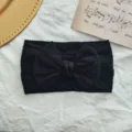 Black elastic nylon baby headband featuring a stylish large cable-knit textured bow accessory - Twisted Bowknot Style / Black