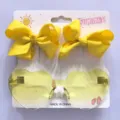 Gelbes Kinder-Set mit Herz-Sonnenbrille und passenden Schleifen-Haarspangen, Sommer - Set aus Haarspange und Sonnenbrille / Gelb