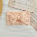 Diadema elástica de nylon para bebé en color melocotón con lazo trenzado. - Estilo de Lazo Torcido / Rosa Melocotón